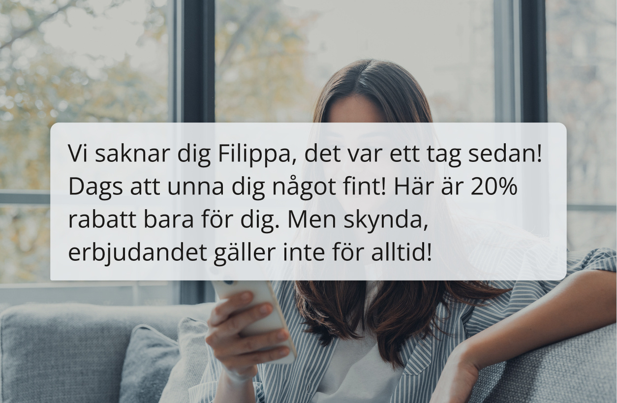 Kvinna läser textmeddelande i soffan